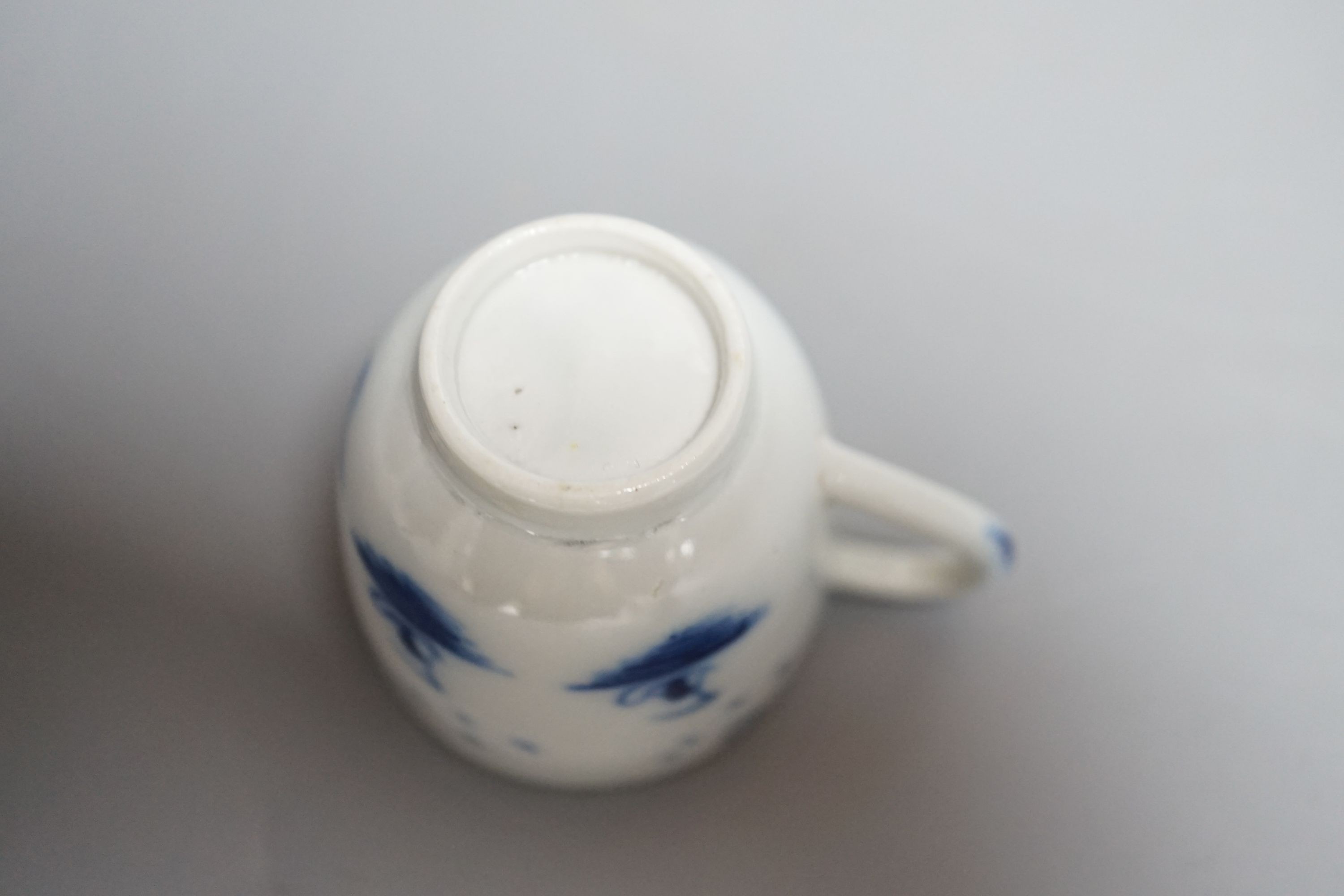 A Caughley 'The Island pattern' blue and white miniature cup, c.1780, 3.4cm. Provenance - Mona Sattin collection of miniature cups and saucers, collection no.16.